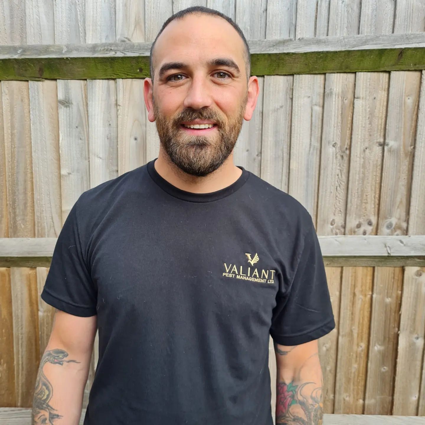 Adam, owner of Valiant Pest Management, in a Valiant T-shirt